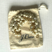 Load image into Gallery viewer, Set of pearl and gold bracelets on a J.Crew branded pouch.