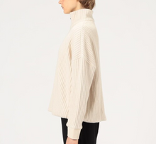 Load image into Gallery viewer, Person wearing a cream-colored ribbed sweater on a white background
