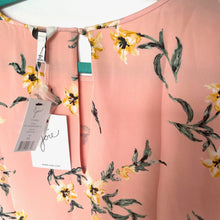 Load image into Gallery viewer, Floral-patterned pink garment with a tag on a white background