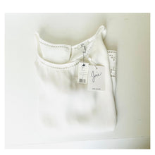 Load image into Gallery viewer, White jeans with a tag on a light gray background