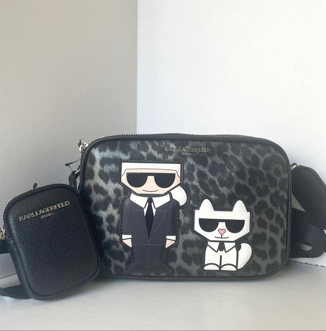 Designer handbag with leopard print and cartoon characters on a white background