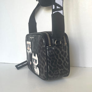 Black leopard print bag with brand tag on a white background