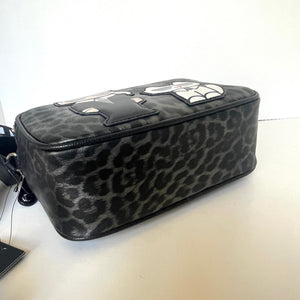 Leopard print makeup bag on a white surface