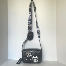 Load image into Gallery viewer, Black crossbody bag with white designs and &#39;Karl Lagerfeld&#39; branding on a light gray background