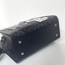 Load image into Gallery viewer, Black handbag with a patterned design on a white background