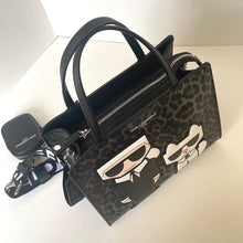 Load image into Gallery viewer, Designer handbag with leopard print and cartoon character on a white background