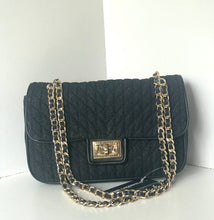 Load image into Gallery viewer, A black quilted Chanel shoulder bag with a gold-tone chain strap and a prominent interlocking CC clasp on the front flap.