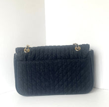 Load image into Gallery viewer, A black quilted leather shoulder bag with gold-tone chain links, displayed on a white surface against a white background.