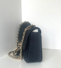 Load image into Gallery viewer, A black textured leather shoulder bag with a gold-tone chain strap, standing on a white surface against a white background.
