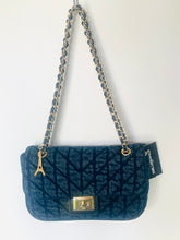 Load image into Gallery viewer, A dark blue quilted velvet shoulder bag with a gold-tone chain strap, a small gold Eiffel Tower charm, and a black brand tag that reads 'D'Orsay'.