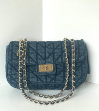 Load image into Gallery viewer, A dark blue quilted monogram shoulder bag with a gold-tone turn-lock clasp and a silver-tone chain strap, displayed against a white background.