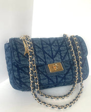 Load image into Gallery viewer, A dark blue quilted denim shoulder bag with a silver-tone chain strap and a gold-tone metal clasp, set against a plain white background.