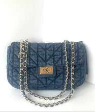Load image into Gallery viewer, A dark blue quilted denim shoulder bag with a silver-tone chain strap and a gold-tone metal clasp, set against a plain white background.