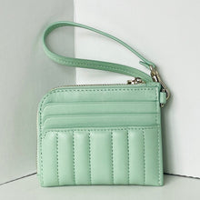 Load image into Gallery viewer, Mint green quilted wallet with a strap on a light gray background