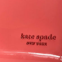 Load image into Gallery viewer, Red surface with 'kate spade new york' embossed text