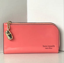 Load image into Gallery viewer, Pink wallet with a gold charm on a light gray background