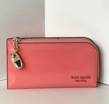 Load image into Gallery viewer, Pink wallet with a gold charm on a light gray background