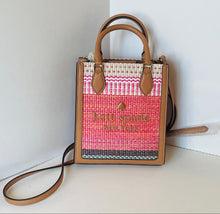Load image into Gallery viewer, Woven handbag with pink and white pattern and brown leather accents on a white surface.