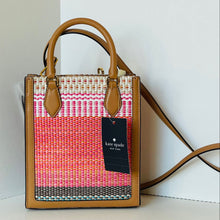 Load image into Gallery viewer, Woven handbag with brown leather accents and a visible Kate Spade tag on a white background