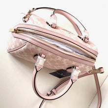 Load image into Gallery viewer, Pink handbag with floral pattern on a light background