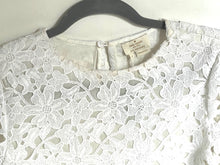 Load image into Gallery viewer, White lace garment on a hanger with a visible brand label.