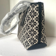 Load image into Gallery viewer, Patterned handbag with black floral design on a white surface