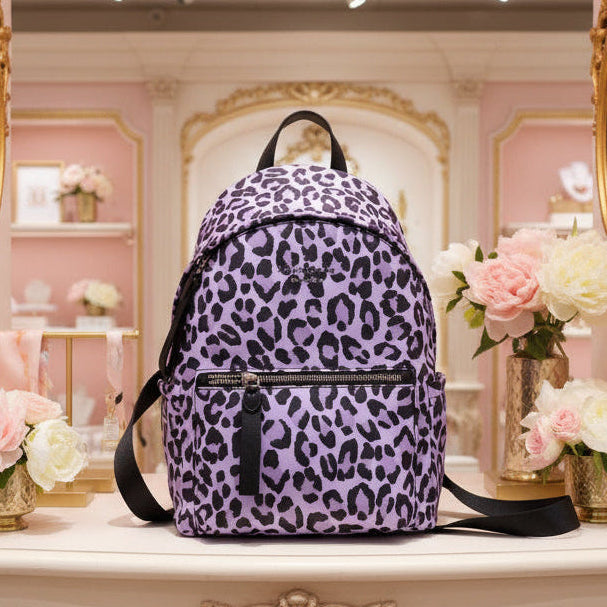 Purple leopard print backpack on a white background
