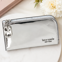 Load image into Gallery viewer, Silver wallet with heart charm on a white surface with flowers