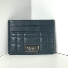 Load image into Gallery viewer, Black quilted cardholder with &#39;kate spade New York&#39; logo on a white background