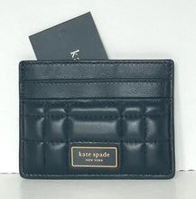 Load image into Gallery viewer, Black quilted cardholder with &#39;kate spade New York&#39; branding on a white background