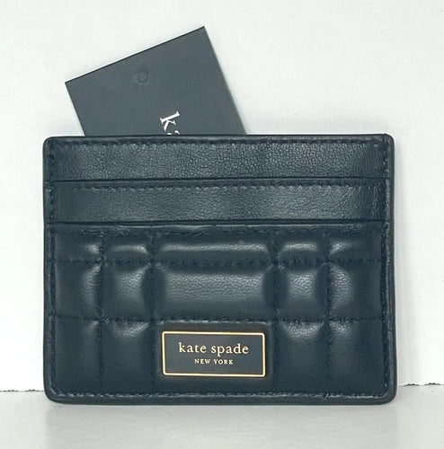 Black quilted cardholder with 'kate spade New York' branding on a white background
