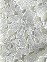 Load image into Gallery viewer, Close-up of white floral lace fabric