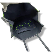 Load image into Gallery viewer, Close-up of a folded mat with green patterns inside a black bag on a white background