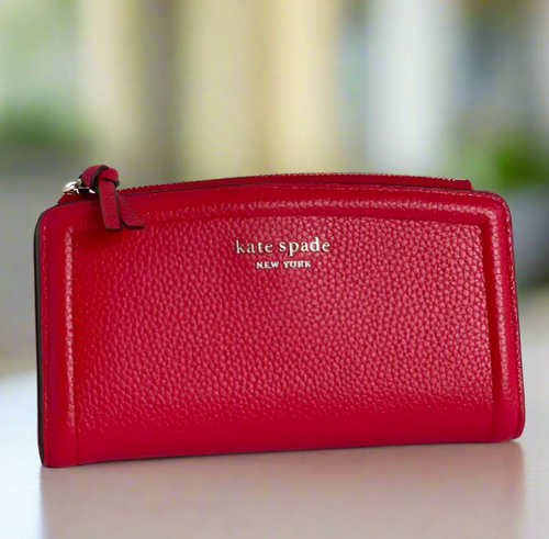 Red wallet with 'kate spade New York' logo on a white background