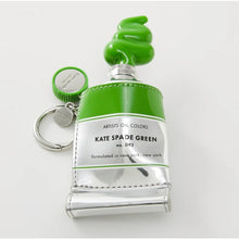 Load image into Gallery viewer, Green and silver keychain shaped like a bottle with 'Kate Spade Green' text on a white background