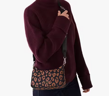Load image into Gallery viewer, Person wearing a maroon sweater holding a leopard print bag on a white background