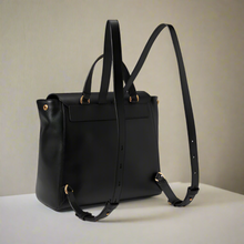 Load image into Gallery viewer, Black backpack with gold hardware on a white background