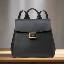 Load image into Gallery viewer, Black backpack with gold clasp on a white background