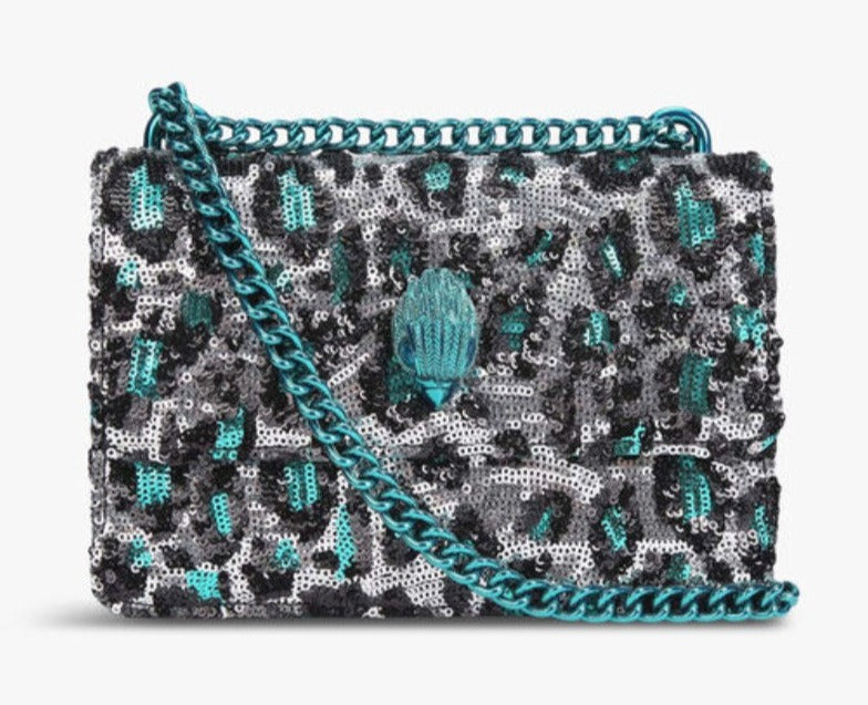 The Small Shoreditch Cross Body from Kurt Geiger London is crafted with leopard print made from sequins. The front flap is topped with teal Eagle head with all over feather detail and green crystal eyes
