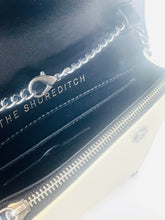 Load image into Gallery viewer, Close-up of a black leather product with 'The Shoreditch' branding on a white background