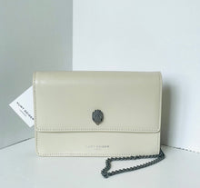 Load image into Gallery viewer, Beige handbag with a chain detail on a light gray background