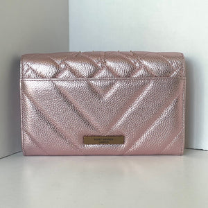 Pink quilted clutch bag with brand logo on a white surface