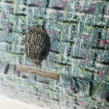 Load image into Gallery viewer, Decorative brooch with 'Kurt Geiger London' label on a textured fabric background