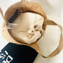 Load image into Gallery viewer, Woven basket with a beige fabric item and a tag on a white surface