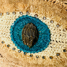 Load image into Gallery viewer, Decorative brooch with blue circular design and gold center on a textured beige background