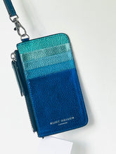 Load image into Gallery viewer, A Kurt Deiger London pebbled leather zip-around card holder with a wristlet strap, featuring a gradient color-blocked design in teal, blue, and navy, with silver hardware.