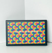 Load image into Gallery viewer, A framed Kurt Geiger London art print featuring a vibrant retro rainbow pattern, leaning against a white wall on a light floor.
