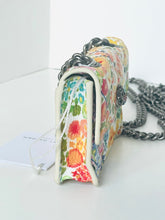 Load image into Gallery viewer, Floral patterned clutch bag with a chain strap on a white background