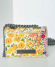 Load image into Gallery viewer, Floral patterned handbag with a chain strap on a light gray background