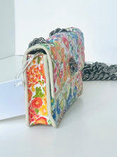 Load image into Gallery viewer, Floral patterned clutch bag on a white surface